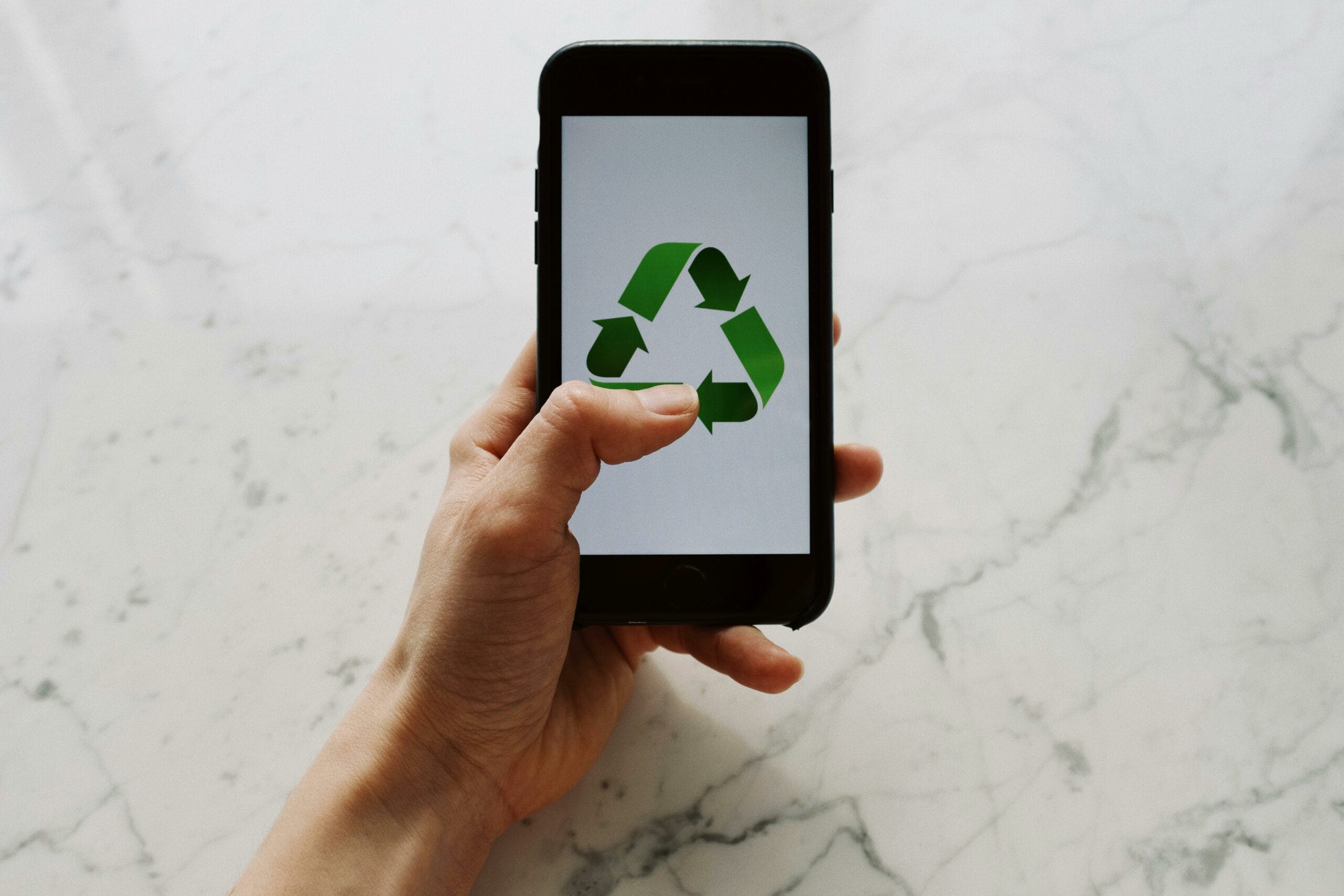 Picture of a phone with a recycling symbol on the screen. Featured image of this Environmental Technology blog series