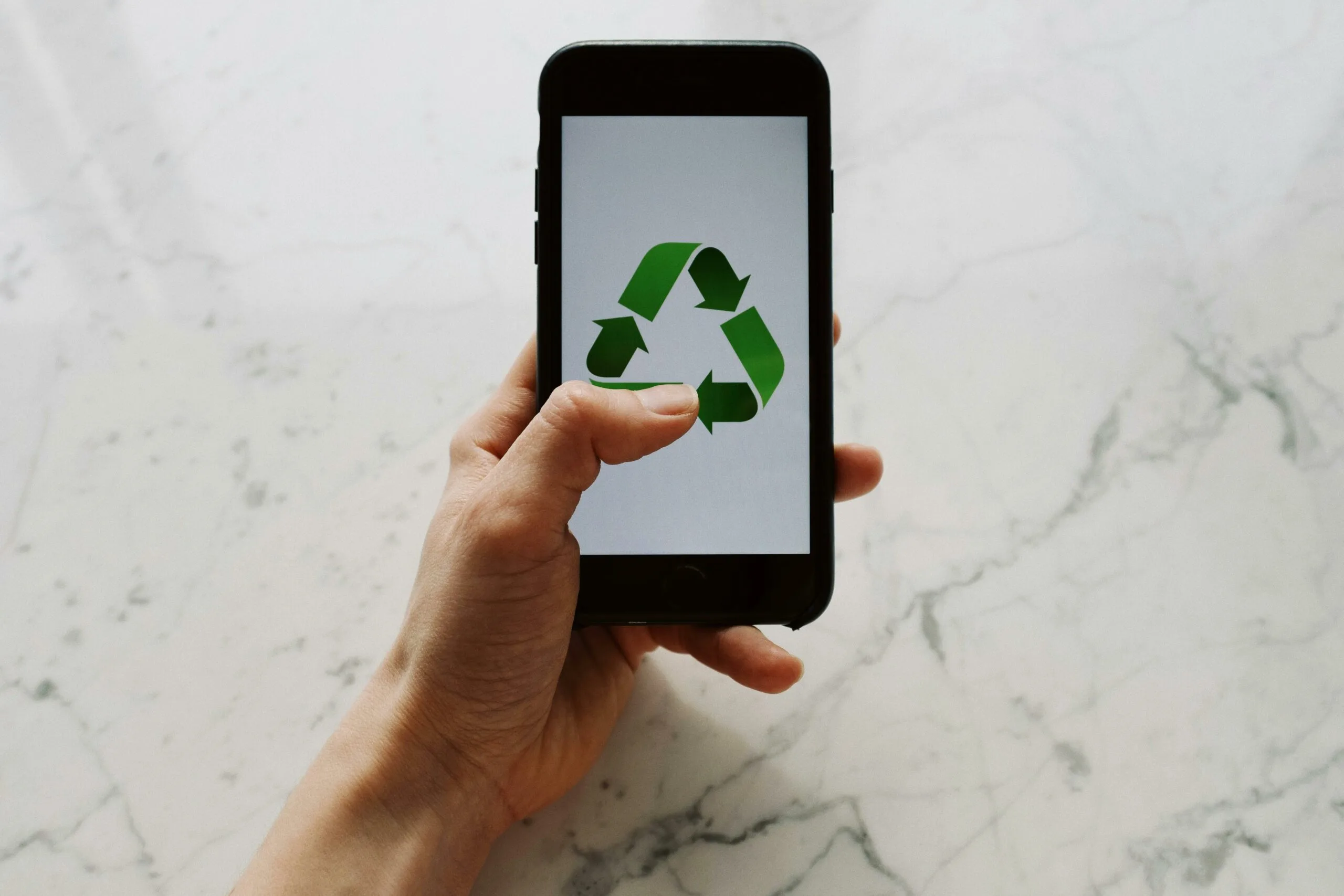 Picture of a phone with a recycling symbol on the screen. Featured image of this Environmental Technology blog series